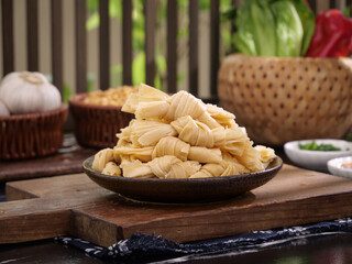Handmade Dried Pasta Noodles in Rustic Kitchen with Fresh Vegetables and Wicker Baskets