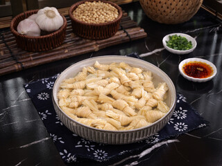 Traditional Asian tofu skin curd rolls with soy beans and bamboo steamer handmade food preparation