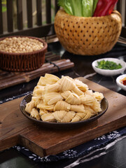 Dried Bean Curd Skin Knots on Wooden Board - Traditional Asian Tofu Food Preparation