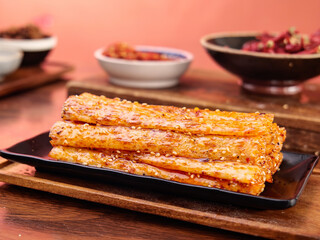 Handmade Spicy Chili Glazed Tofu Sticks with Asian Dipping Sauces and Sesame Seeds
