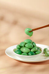 Green Olives in Bowl with Wooden Chopsticks - Mediterranean Food Appetizer