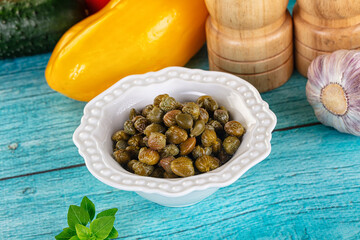 Pickled canned capers in the bowl
