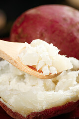 Cottage Cheese on Wooden Spoon with Red Potato Background - Healthy Dairy and Vegetable Food Ingredients