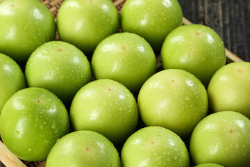 Fresh Green Taiwanese Jujube Winter Dates with Water Droplets in Wicker Basket