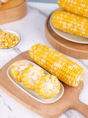 Fresh Sweet Corn Cobs and Kernels on Wooden Board - Healthy Organic Vegetable Food Ingredient