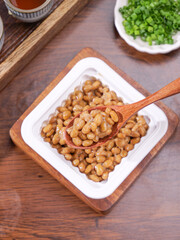 Japanese Natto Fermented Soybeans in Bowl with Wooden Spoon Traditional Healthy Food