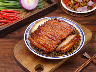 Traditional Chinese Braised Pork Belly with Preserved Vegetables and Chopsticks on Wooden Table