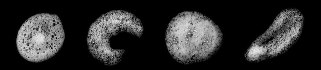 Abstract soap bubbles set, shampoo or shaving cream. Isolated soap bubbles on black background with...