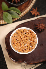 Japanese Natto Fermented Soybeans in Bowl with Traditional Asian Spices and Bamboo Basket