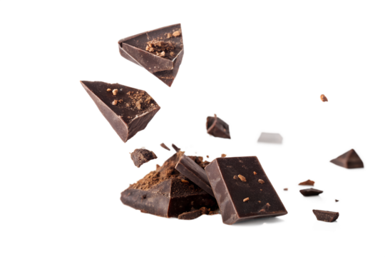 Broken chocolate pieces floating against a dark background