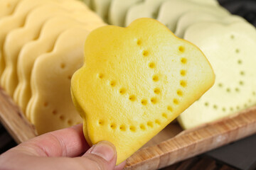 Handmade Lotus Leaf Shaped Bread Slice Being Displayed on Wooden Board