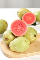 Fresh Guava Fruit with Red Heart Flesh on Light Background