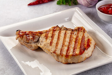 Tasty hot grilled bone steak served sauce