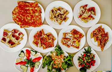 Delicious meat kebab with fresh vegetable salad served with variety of Turkish dishes and appetizers. Top view of assorted Turkish food and meze, tasty and healthy Mediterranean cuisine. Top view.