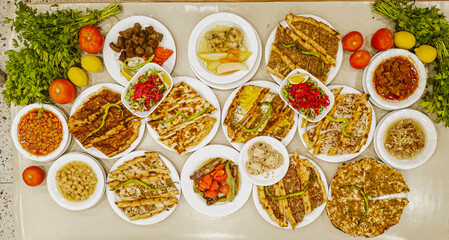 Delicious meat kebab with fresh vegetable salad served with variety of Turkish dishes and appetizers. Top view of assorted Turkish food and meze, tasty and healthy Mediterranean cuisine. Top view.