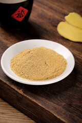 Fresh Ginger Powder in Bowl on Wooden Cutting Board - Natural Spice Ingredient for Cooking and Baking