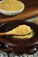 Fresh Ground Ginger Powder Spice in Wooden Spoon - Natural Healthy Seasoning Ingredient Display