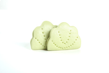Heart-Shaped Green Sandwich Cookies with Decorative Patterns on White Background