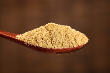 Ginger Powder on Wooden Spoon - Natural Spice Ingredient for Cooking and Baking