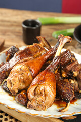 Roasted Goose Legs with Crispy Skin on Rustic Farmhouse Table - Traditional Cured Poultry Deliciousness