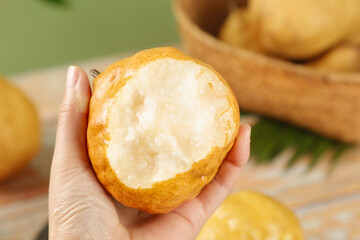Fresh Chinese Asian Pear Cut in Half Showing White Flesh and Core in Hand