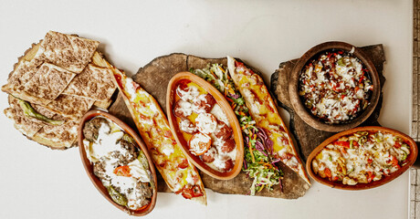 Delicious meat kebab with fresh vegetable salad served with variety of Turkish dishes and appetizers. Top view of assorted Turkish food and meze, tasty and healthy Mediterranean cuisine. Top view.