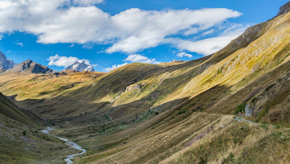 landscape in the Aosta valley with Mont Blanc in the background and a torrent flowing at the bottom of the valley in Italy