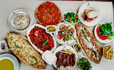 Delicious meat kebab with fresh vegetable salad served with variety of Turkish dishes and appetizers. Top view of assorted Turkish food and meze, tasty and healthy Mediterranean cuisine. Top view.