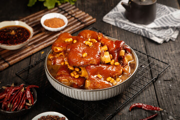 Spicy braised pork feet stew with soya beans in savory sauce - traditional Asian comfort food dish