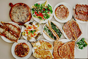 Delicious meat kebab with fresh vegetable salad served with variety of Turkish dishes and appetizers. Top view of assorted Turkish food and meze, tasty and healthy Mediterranean cuisine. Top view.