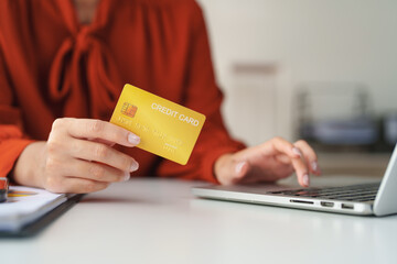 Businesswoman making online payment using credit card and laptop