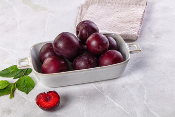 Raw ripe purple plum heap