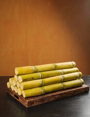 Fresh Sugar Cane Stalks on Wooden Board - Natural Yellow Green Tropical Plant Ingredient