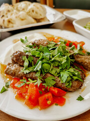 Delicious meat kebab with fresh vegetable salad served with variety of Turkish dishes and appetizers. Top view of assorted Turkish food and meze, tasty and healthy Mediterranean cuisine. Top view.