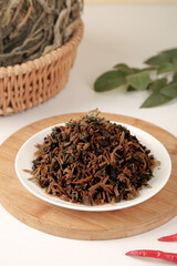 Traditional Chinese Dried Salted Cabbage and Plum Ingredients on Wooden Board