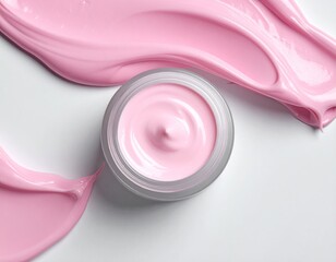 Light pink cosmetic cream in a jar, swirled on a white background