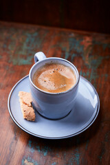 Cup of coffee on rustic wooden background. Soft focus. Copy space	
