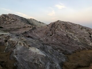View of rocky mountains with textured surfaces under a bright sky during the daytime scenery outdoors