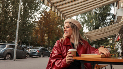 Woman enjoying coffee at a cafe on a sunny day