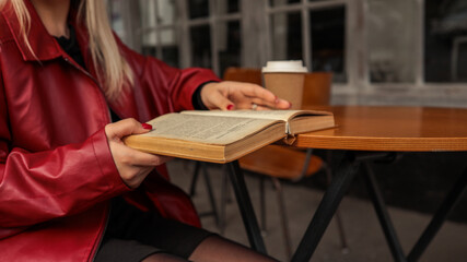 Woman reading a book at a cafe