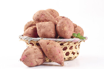 Fresh Sweet Potatoes in Wicker Basket on White Background