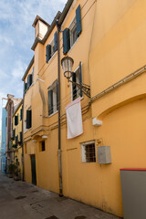 picturesque yellow house on narrow lane near Vena canal, Chioggia, Italy