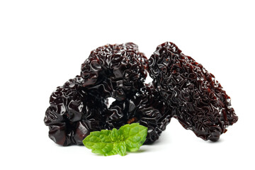 Big Black Dried Xinjiang Dates with Mint Leaves on White Background