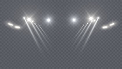 Bright white spotlights with intersecting beams of light on a transparent background. A realistic stage lighting effect for concerts, theaters, fashion shows, and digital design compositions.
