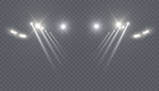 Bright white spotlights with intersecting beams of light on a transparent background. A realistic stage lighting effect for concerts, theaters, fashion shows, and digital design compositions.