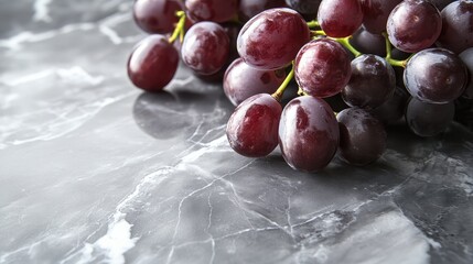Fresh red grapes on a marble surface creating a healthy food backdrop
