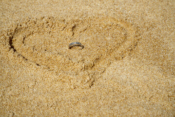 Close-up of a platinum diamond ring in a love pattern, love, marriage, top view
