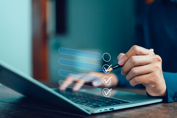 Businessman working on computer using laptop. Concept of business performance tracking and evaluation. Document management system DMS. Performance checklist evaluation form.