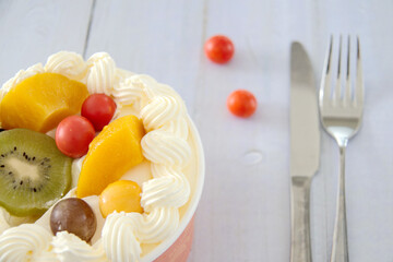 Close-up on a wooden table cream with kiwi, cherry tomatoes, depth of field