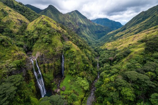 Lush valley with waterfalls cascading down green mountains